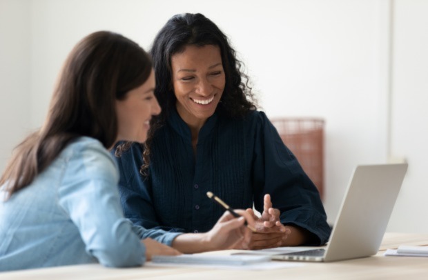 Two professional women discuss their careers in the insurance industry.